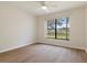 Bedroom featuring wood floors and a large window at 9397 Merriweather Dr, Weeki Wachee, FL 34613