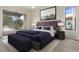 Stylishly staged bedroom featuring a plush bed, modern artwork, and sliding door access to the outdoors at 9397 Merriweather Dr, Weeki Wachee, FL 34613