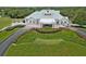Low aerial showing the clubhouse exterior and surrounding green space at 9397 Merriweather Dr, Weeki Wachee, FL 34613