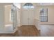 Bright entryway featuring double doors, transom window, and wood-look floors at 9397 Merriweather Dr, Weeki Wachee, FL 34613