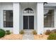 Close up of the double door entryway flanked by decorative windows at 9397 Merriweather Dr, Weeki Wachee, FL 34613