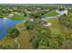 Aerial view of golf course, waterways, and trees with community homes nearby at 9397 Merriweather Dr, Weeki Wachee, FL 34613