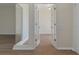Hallway featuring light wood floors, neutral walls, french doors and a mirror at 9397 Merriweather Dr, Weeki Wachee, FL 34613