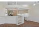 Open kitchen featuring stainless steel appliances, white cabinets, and a breakfast bar with built-in shelving at 9397 Merriweather Dr, Weeki Wachee, FL 34613