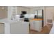 Well-lit kitchen boasting stainless steel appliances, white cabinets, and white countertops at 9397 Merriweather Dr, Weeki Wachee, FL 34613