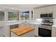 Kitchen with stainless steel appliances, white countertops, and a beautiful view at 9397 Merriweather Dr, Weeki Wachee, FL 34613