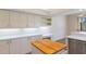 Kitchen with stainless steel appliances, white cabinets, and white countertops at 9397 Merriweather Dr, Weeki Wachee, FL 34613