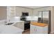 Modern kitchen with stainless steel appliances, white cabinets, and white countertops at 9397 Merriweather Dr, Weeki Wachee, FL 34613