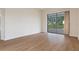 Bright living room with sliding glass doors offering serene views of the pool and outdoor area at 9397 Merriweather Dr, Weeki Wachee, FL 34613