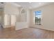 Spacious living room with vaulted ceilings, light wood floors, and a view through the large window at 9397 Merriweather Dr, Weeki Wachee, FL 34613