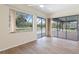 Well-lit living room with expansive windows and sliding doors providing serene outdoor views and access at 9397 Merriweather Dr, Weeki Wachee, FL 34613