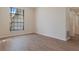 Bright living room with wood floors, white trim, and a large window allowing natural light at 9397 Merriweather Dr, Weeki Wachee, FL 34613