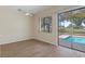 Cozy living room with a ceiling fan and sliding doors that offer a view of the outdoor pool area at 9397 Merriweather Dr, Weeki Wachee, FL 34613