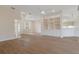 Open living room featuring built-in shelving and a seamless transition to the kitchen at 9397 Merriweather Dr, Weeki Wachee, FL 34613
