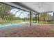 Screened in lanai featuring a large pool and a brick paver patio at 9397 Merriweather Dr, Weeki Wachee, FL 34613