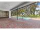 Screened in lanai featuring a large pool and brick paver patio at 9397 Merriweather Dr, Weeki Wachee, FL 34613