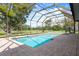 The large screened in pool includes an adjacent spa with brick paver decking at 9397 Merriweather Dr, Weeki Wachee, FL 34613
