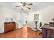 Bright bedroom with hardwood floors, ceiling fan, and traditional furnishings at 9432 Amidon St, Spring Hill, FL 34608