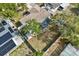 Aerial view of a spacious backyard with a privacy fence, mature tree, screened patio and small storage shed at 9511 Marlinton Ln, Port Richey, FL 34668