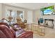 Inviting living room with tile flooring, comfortable seating, and a large window for natural light at 9511 Marlinton Ln, Port Richey, FL 34668