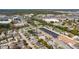 Wide aerial shot showing the home's proximity to a park, shopping centers, and a water feature at 10245 Regency Park Blvd, Port Richey, FL 34668