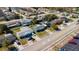 Neighborhood aerial view of a single-story home with mature trees and proximity to local amenities at 10245 Regency Park Blvd, Port Richey, FL 34668