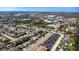 Wide aerial shot showing the home's proximity to a park, shopping centers, and a water feature at 10245 Regency Park Blvd, Port Richey, FL 34668