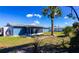 Spacious backyard featuring a screened in lanai, lush greenery and shade from trees at 10245 Regency Park Blvd, Port Richey, FL 34668