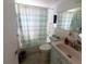 Cozy bathroom features a shower and tub combination, toilet, vanity with sink, and updated fixtures at 10245 Regency Park Blvd, Port Richey, FL 34668