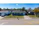 Street view showcasing the blue home with a well-maintained lawn and a private driveway at 10245 Regency Park Blvd, Port Richey, FL 34668