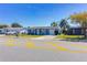Inviting single-story house featuring a blue exterior, attached garage, and established landscaping at 10245 Regency Park Blvd, Port Richey, FL 34668