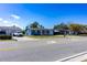 A blue home on a street surrounded by well-maintained lawns and driveways at 10245 Regency Park Blvd, Port Richey, FL 34668