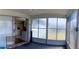 Sunroom with sliding glass doors to the kitchen, carpet flooring, and natural lighting at 10245 Regency Park Blvd, Port Richey, FL 34668