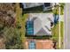 Aerial view of the home, highlighting the pool, landscaping, and overall property layout at 10407 Audie Brook Dr, Spring Hill, FL 34608