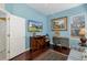 Bedroom featuring a desk, TV, painting, and hardwood floors at 10407 Audie Brook Dr, Spring Hill, FL 34608