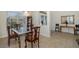 Formal dining room with a glass-top table, elegant chandelier, and decorative china cabinet at 10407 Audie Brook Dr, Spring Hill, FL 34608