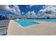 Community pool features lounge seating, splash pad area, and access to the lagoon at 10823 Penny Gale Loop, San Antonio, FL 33576