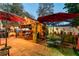 Beautiful outdoor entertaining area with seating, umbrellas, and a custom wooden structure for relaxation at 1086 Hook Dr, Spring Hill, FL 34608