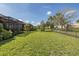 A spacious backyard with lush lawn, mature landscaping, and fenced perimeter, providing a private outdoor retreat at 11383 Callisia Dr, Odessa, FL 33556