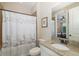 Bathroom featuring tile shower with decorative curtain, granite vanity, toilet, and mirror at 11383 Callisia Dr, Odessa, FL 33556