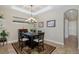 Bright dining room with decorative coffered ceiling, chandelier, and large patterned rug at 11383 Callisia Dr, Odessa, FL 33556