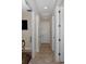 Hallway with tile flooring, white doors, modern hardware, and an abundance of lighting at 11383 Callisia Dr, Odessa, FL 33556