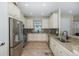 Bright kitchen featuring stainless steel appliances, granite countertops, and mosaic tile backsplash at 11383 Callisia Dr, Odessa, FL 33556