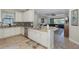 Well-lit kitchen featuring white cabinets, stainless steel appliances, and an open floorplan at 11383 Callisia Dr, Odessa, FL 33556