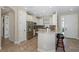 Well-lit kitchen featuring white cabinets, stainless steel appliances, and a breakfast bar at 11383 Callisia Dr, Odessa, FL 33556