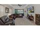 Living room featuring a leather sectional sofa, ceiling fan, and an open floorplan to the outdoors at 11383 Callisia Dr, Odessa, FL 33556