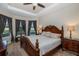 The main bedroom features a ceiling fan, carpeted floor and large windows at 11383 Callisia Dr, Odessa, FL 33556