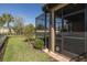 Exterior view of a screened-in patio, well manicured lawn, and lush green hedges at 11383 Callisia Dr, Odessa, FL 33556