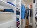 Organized walk-in closet featuring shelving and hanging storage for optimal storage solutions at 11383 Callisia Dr, Odessa, FL 33556