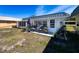 Back patio with furniture and potted plants on the back of the home at 11713 Boynton Ln # 74A, New Port Richey, FL 34654